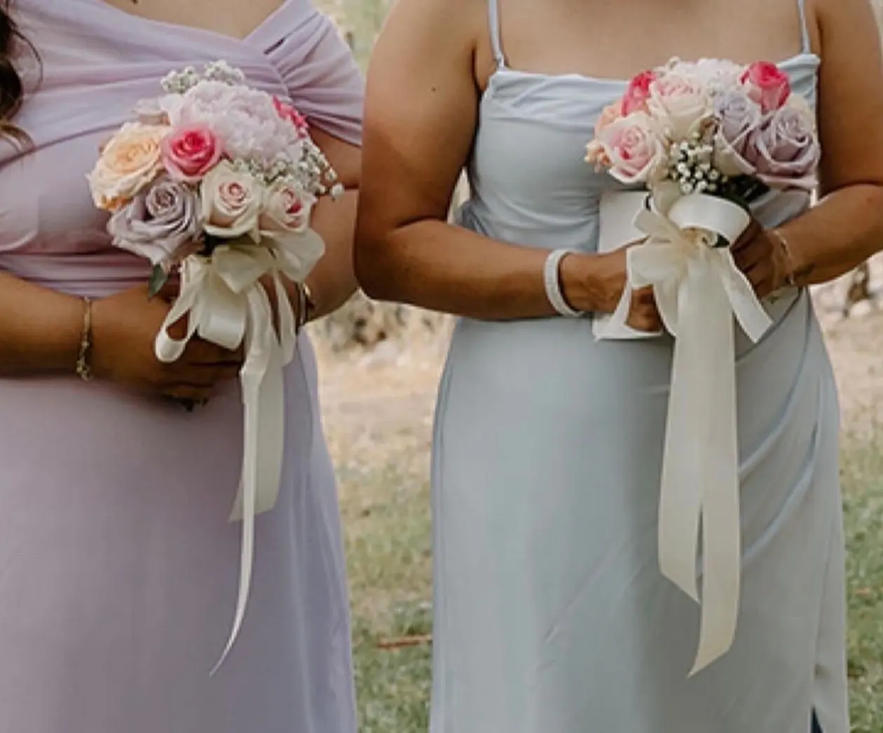 Two bridesmaids holding pink and white rose bouquets, wedding bouquets Tucson AZ