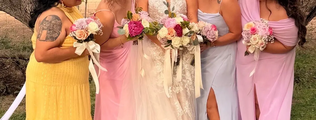 Bridesmaids in pastel dresses holding rose bouquets, wedding bouquets Tucson AZ