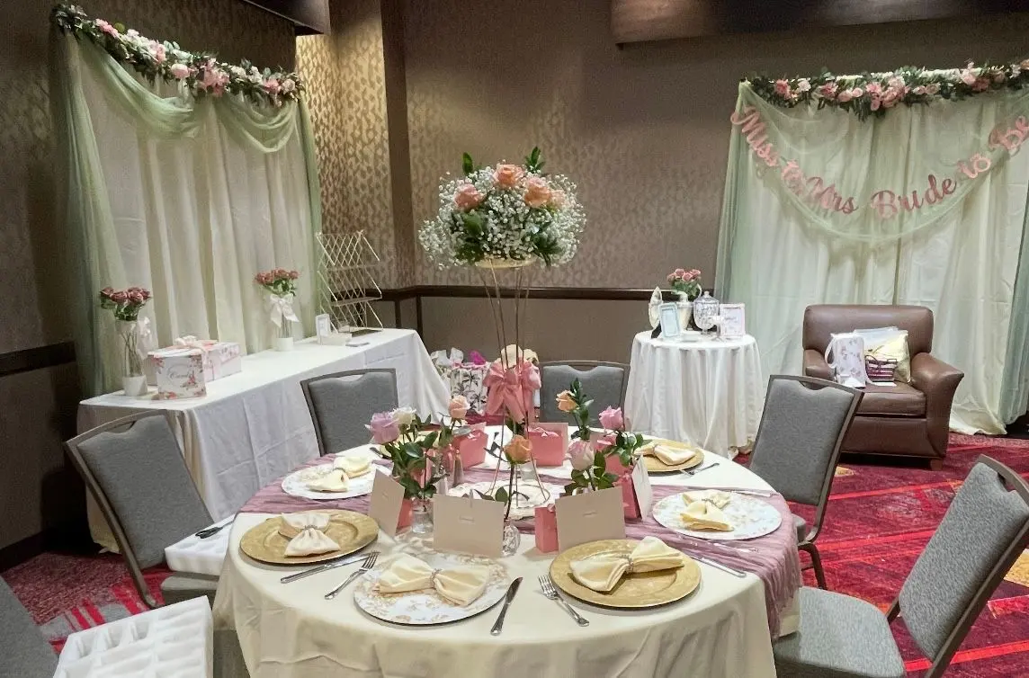 Event venue with floral centerpieces and draped head table, Tucson