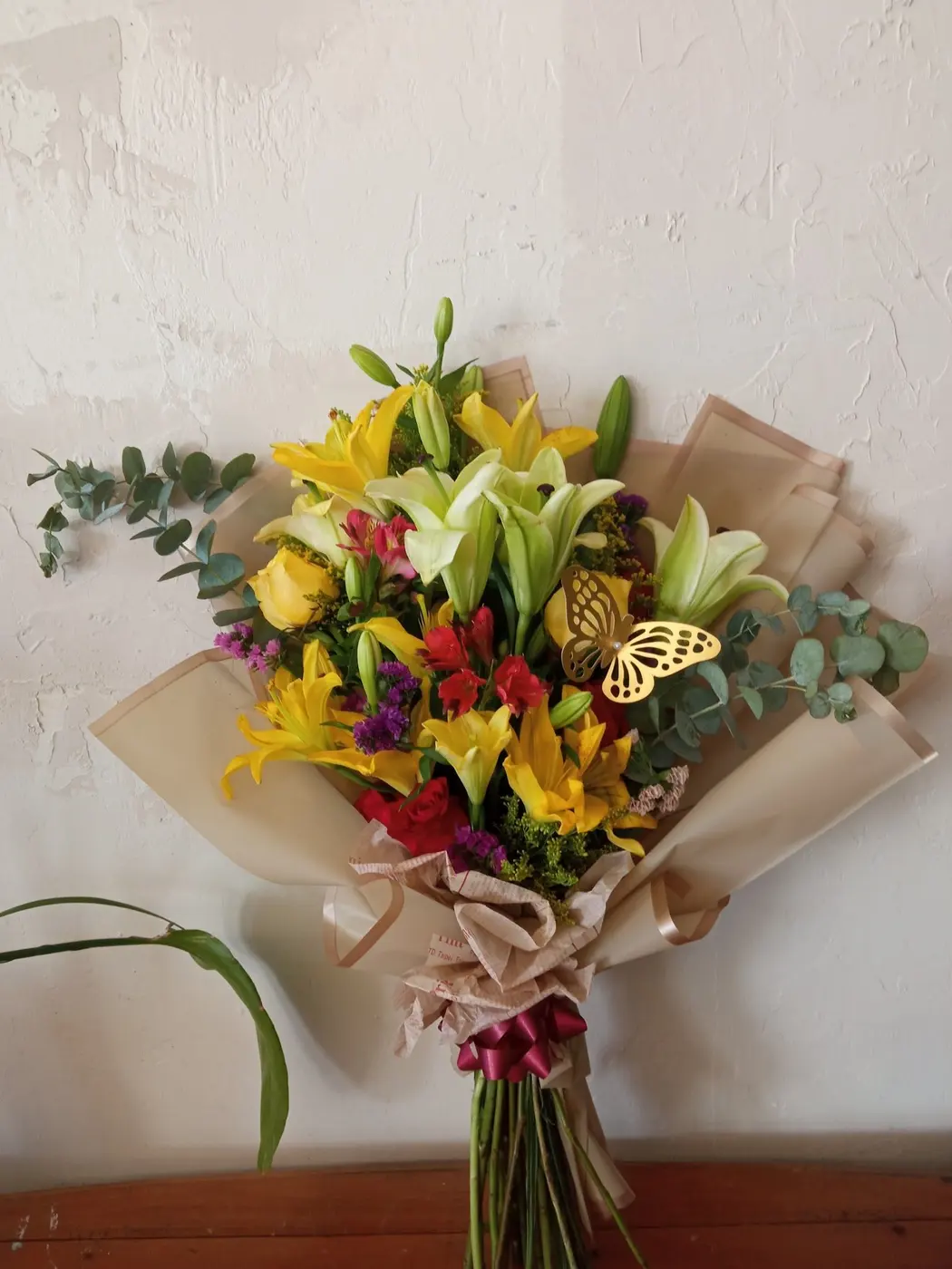 Kraft-wrapped bouquet of yellow lilies and red roses, Wholesale Flowers Tucson